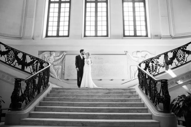 Mariés au pied d’un grand escalier d’honneur – photographe de mariage à Reims