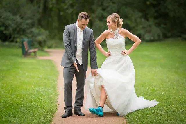 Mariée montrant ses baskets, moment complice – photographe de mariage à Reims